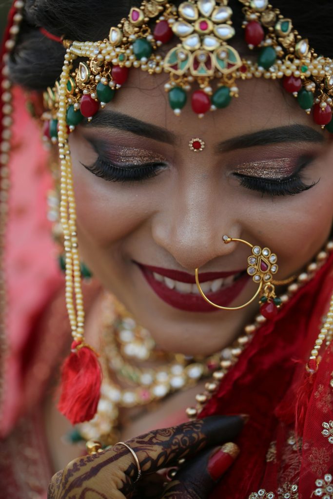 Close-up of a beautiful Indian bride showcasing traditional jewelry and makeup.